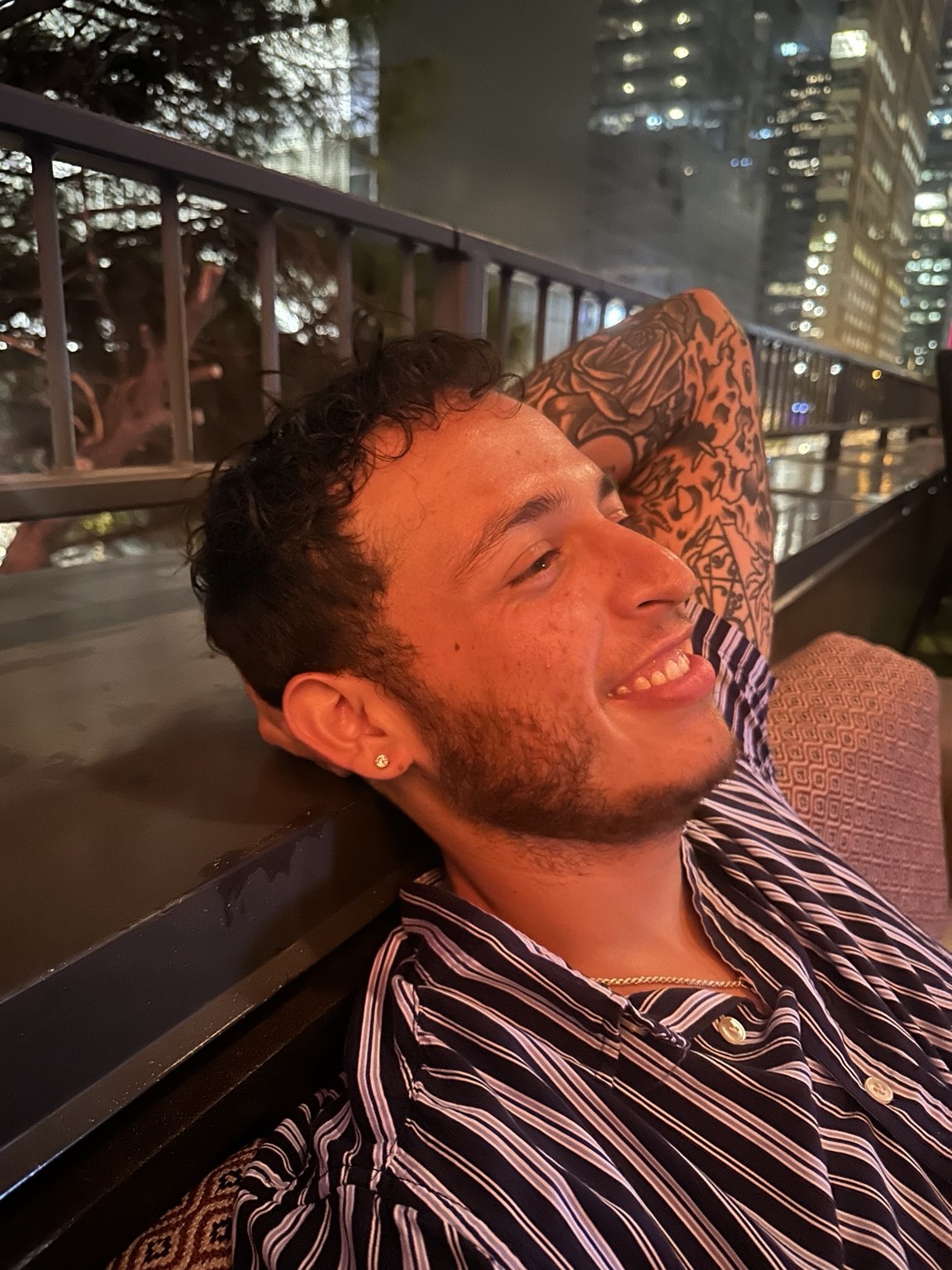 Oscar smiling outdoors at night